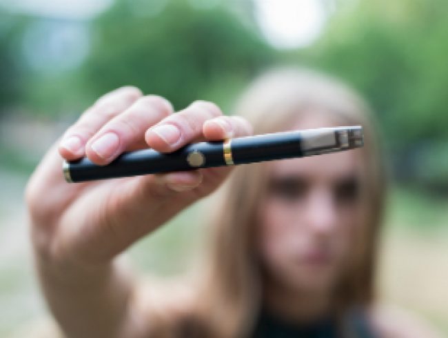 Q: How does ‘vaping’ e-cigarettes differ from smoking traditional cigarettes?